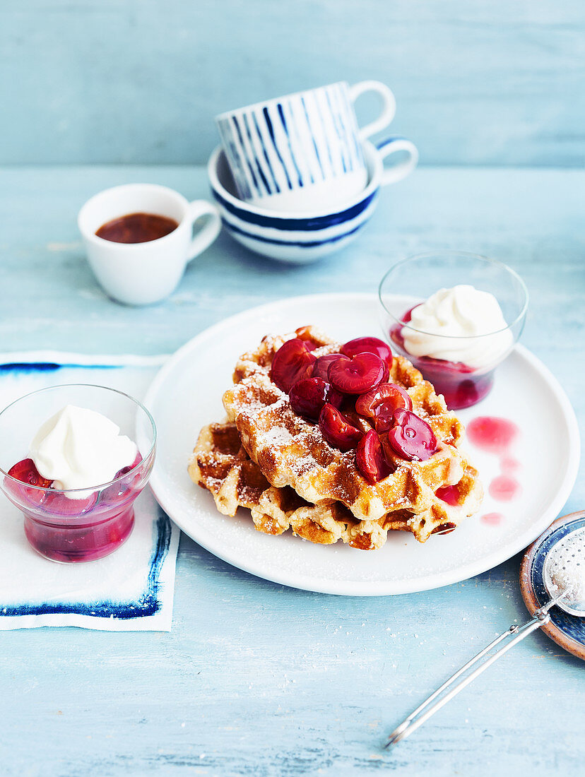 Waffles with sweet cherry compote and vanilla cream