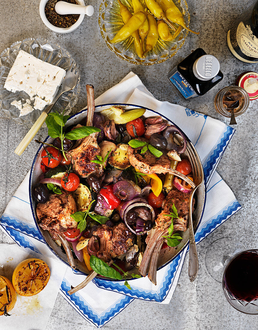 Lamb chops and grilled vegetables with basil, lemons, olives, anchovies and feta cheese