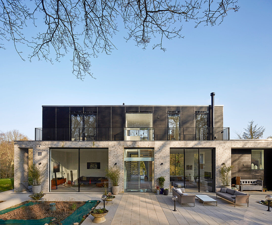 Modern architect-designed house with glass walls and flat roof