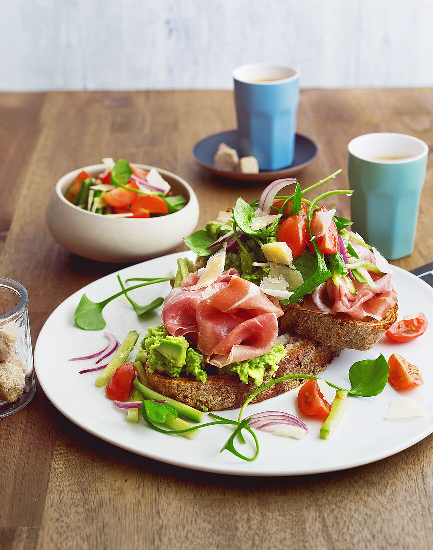 Country bread with avocado cream, Parma ham and cherry tomatoes