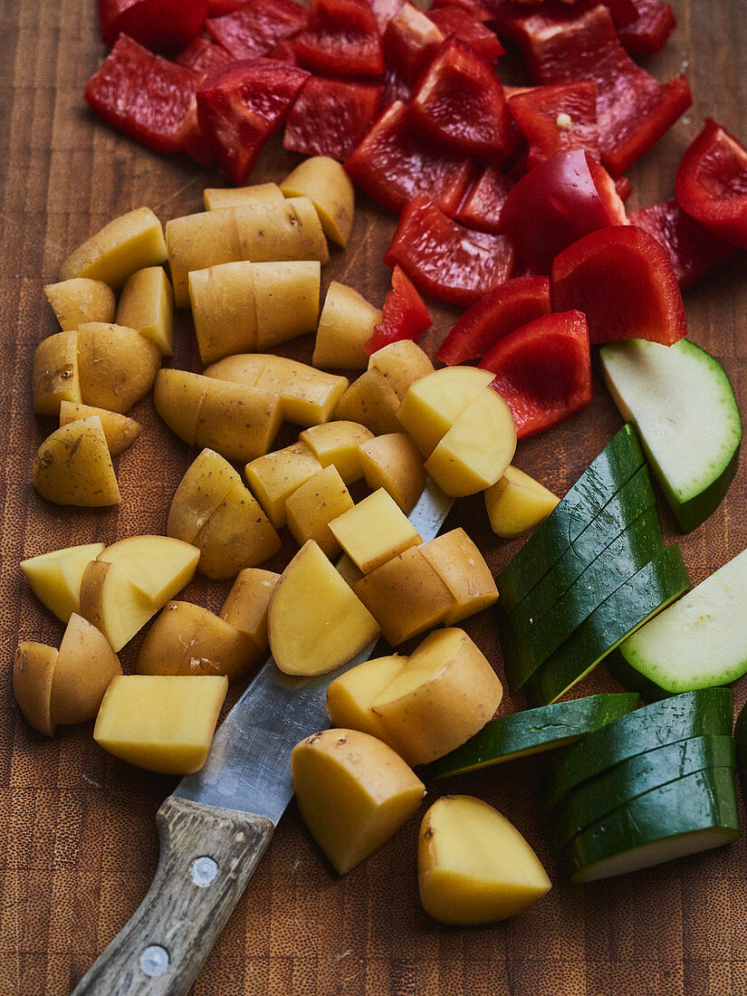 Potatoes, peppers and courgettes being sliced