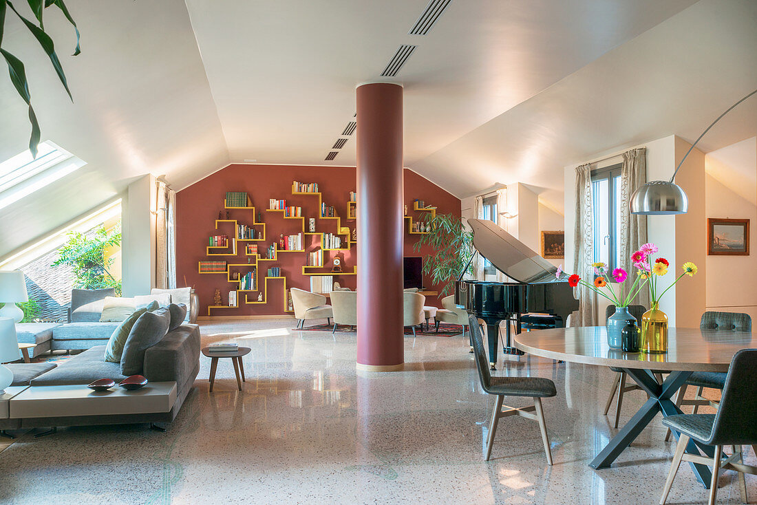 Elegant dining area and lounge in open-plan interior with sloping ceiling