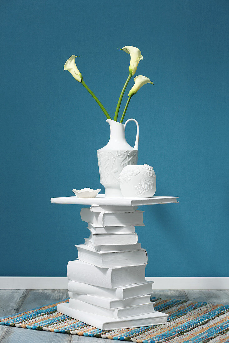 Side table made from stack of books painted white