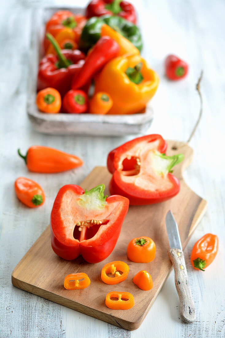 Red and yellow peppers, partly sliced