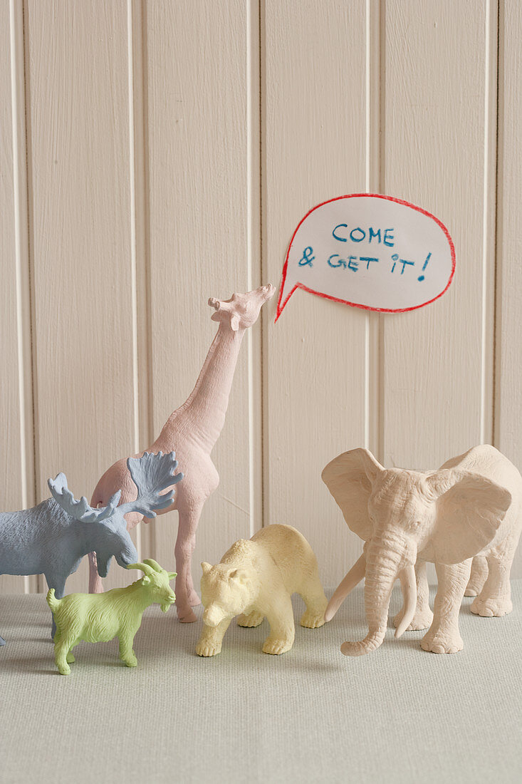 Various animal figures with a speech bubble