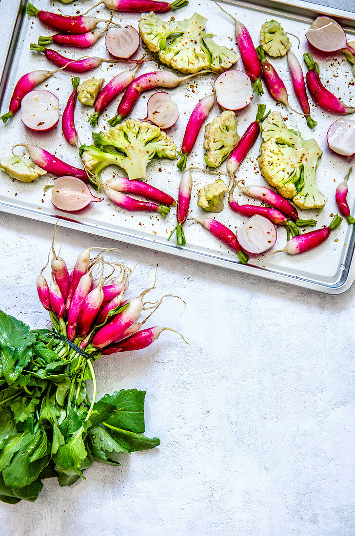 Roasted radishes and cauliflower on a backing tray