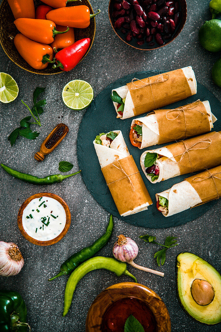 Tortilla wraps with vegetables, surrounded by the ingredients (Mexico)