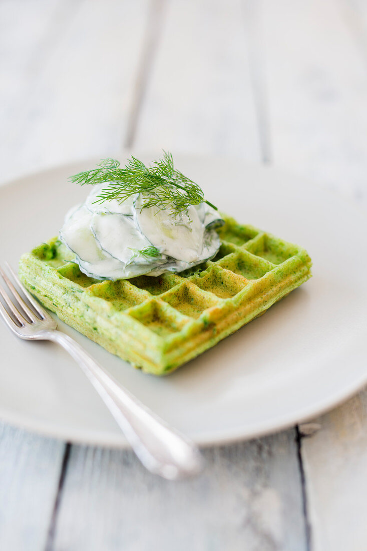 A vegan pea waffle with cucumber yogurt