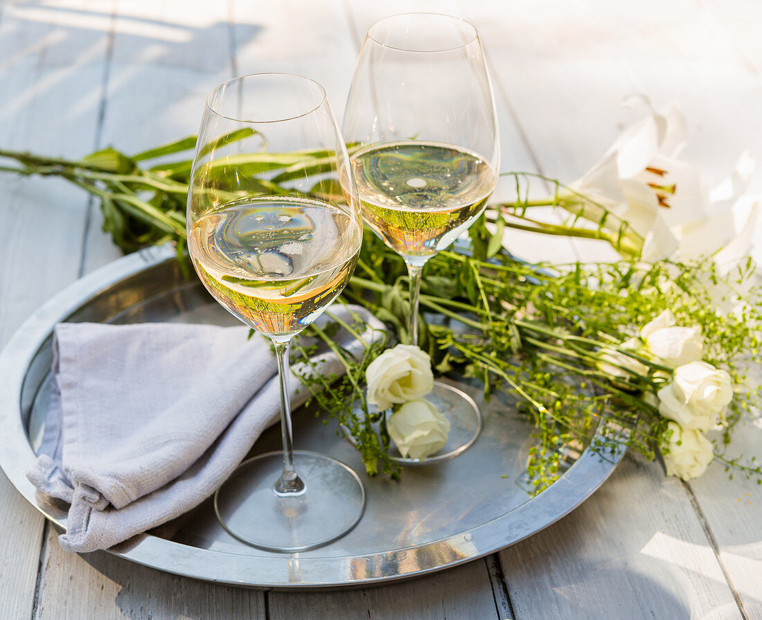 Glasses of Sparkling Wine on outdoor table with