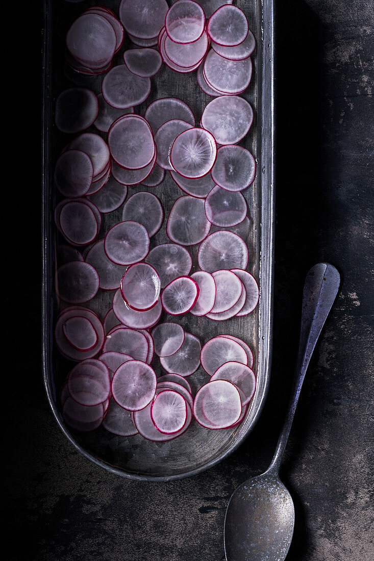 Sliced radishes in tray