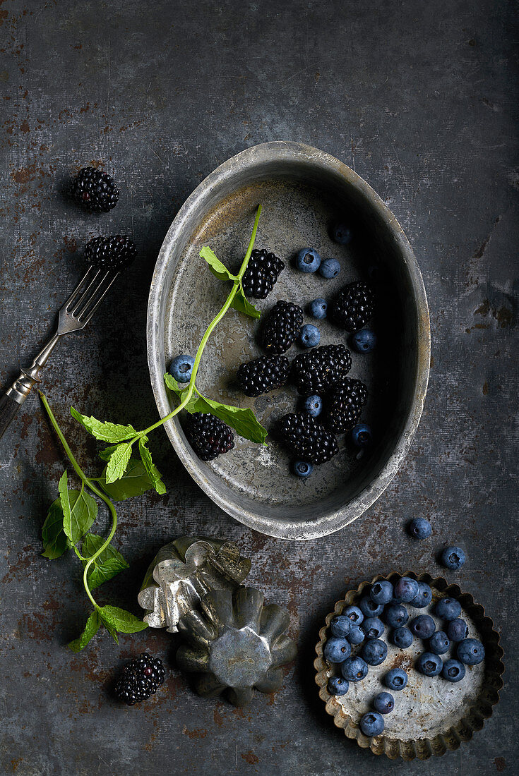 Still life of blueberries, black berries and mint