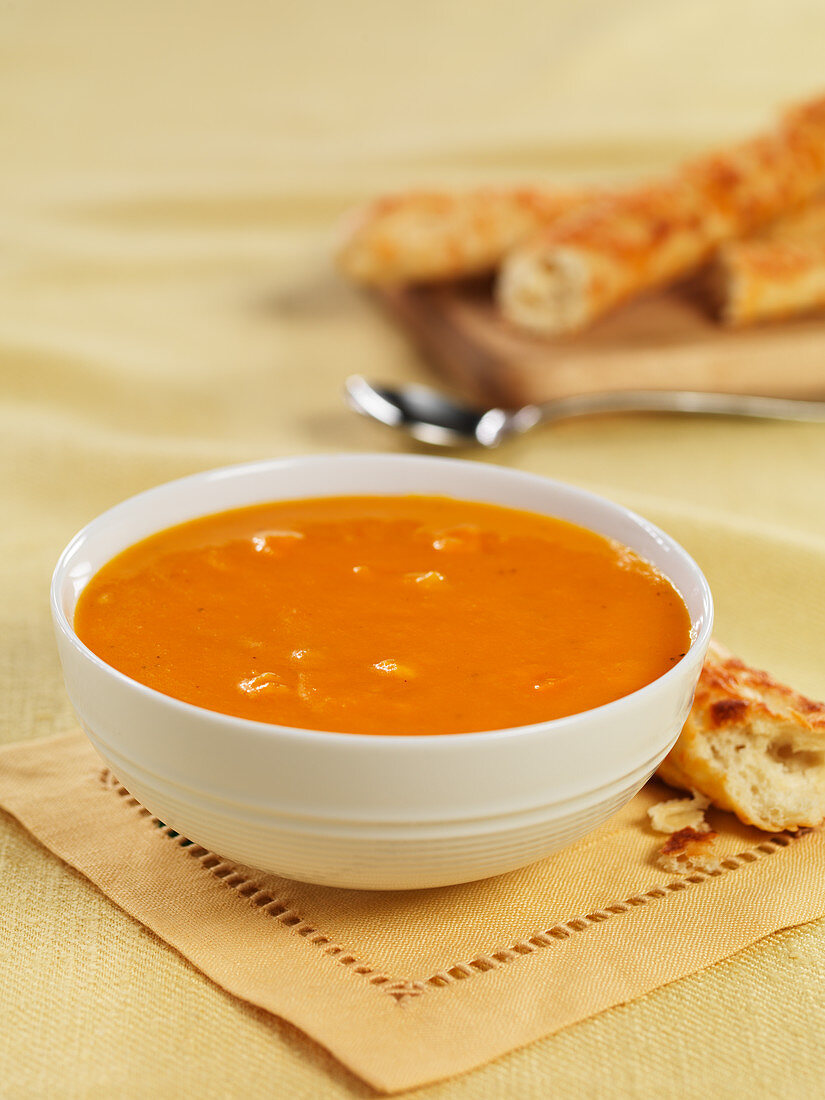 Carrot soup with bread sticks