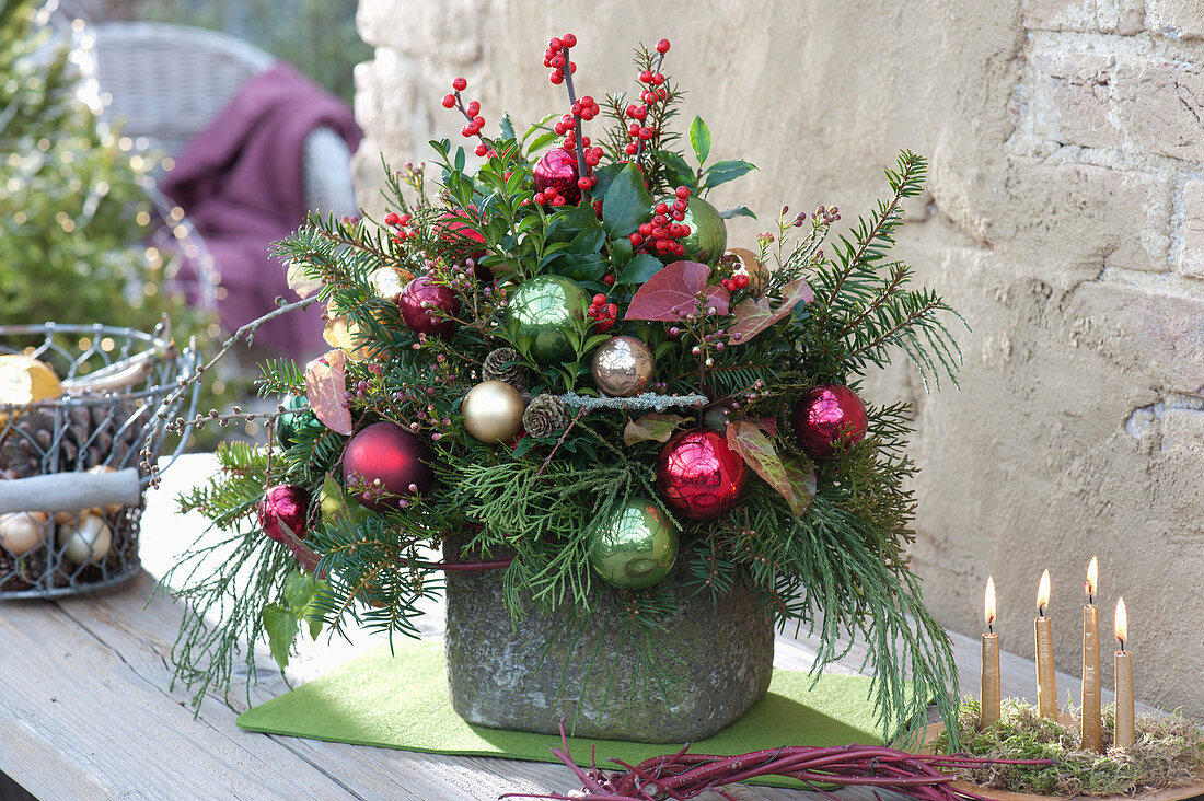Christmas arrangement with conifer branches and Christmas baubles