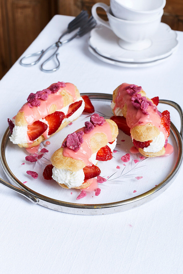 Eclairs with strawberries and cream