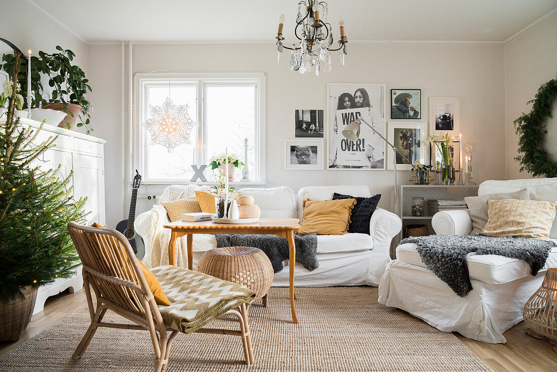 Sofa and armchairs in living room in natural shades