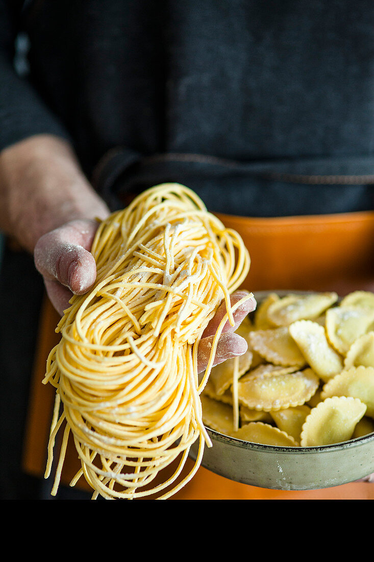 A man holding homemade pasta