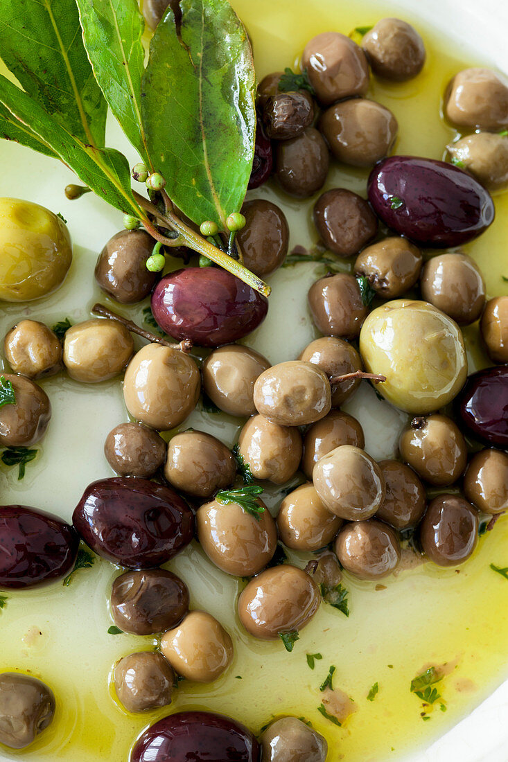 Olives in olive oil with bay leaves