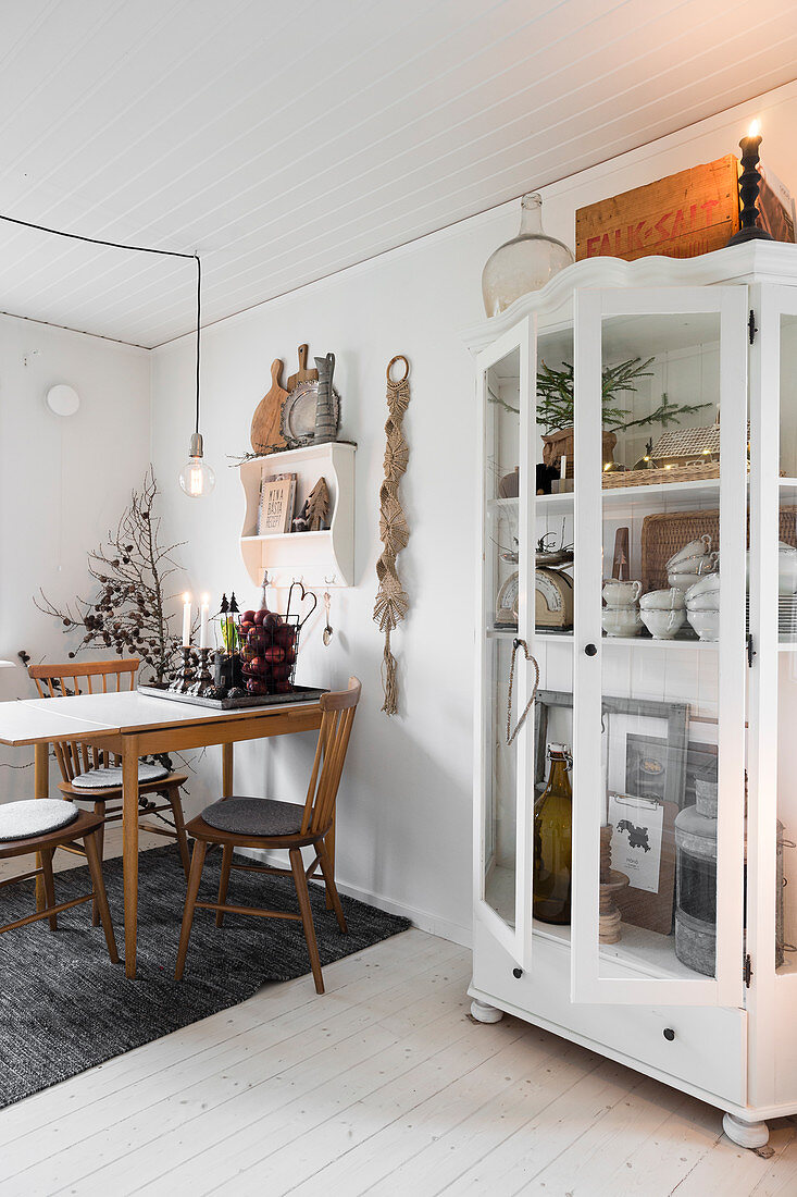 Old glass-fronted cabinet in festively decorated dining room