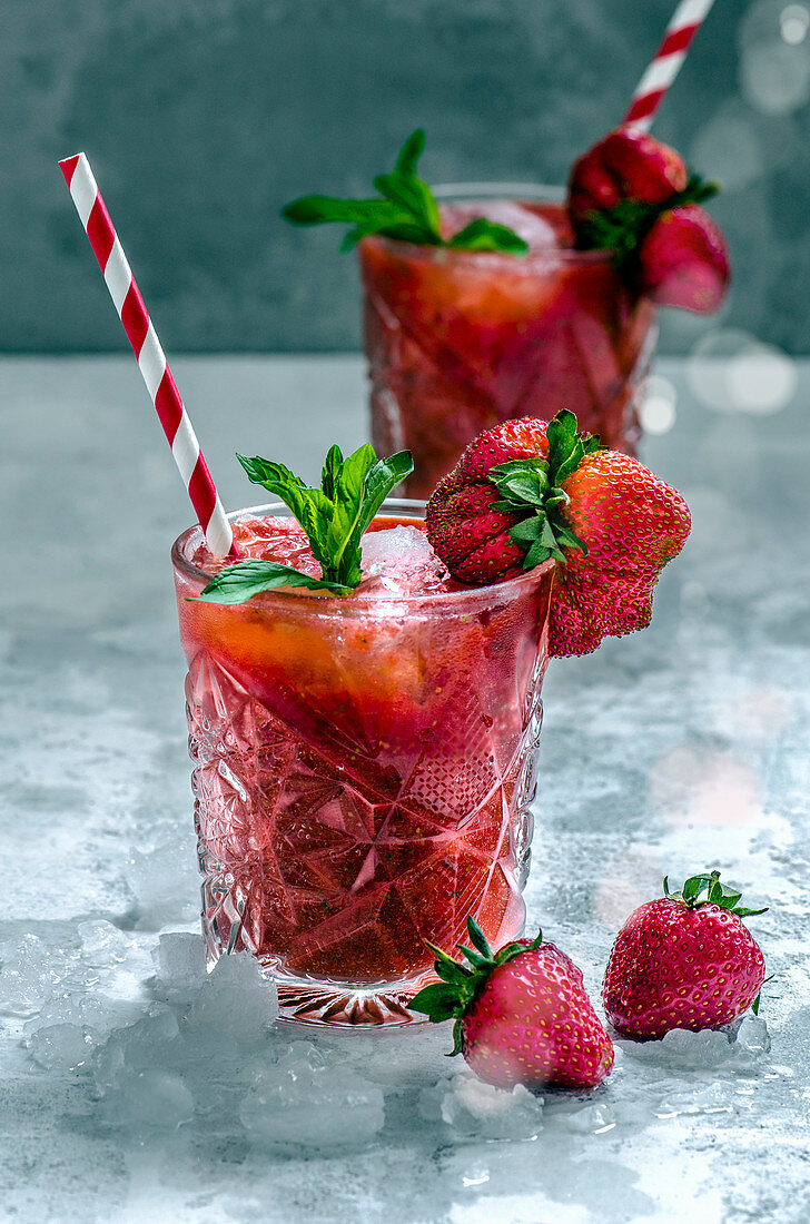 Strawberry drinks in glasses with straws