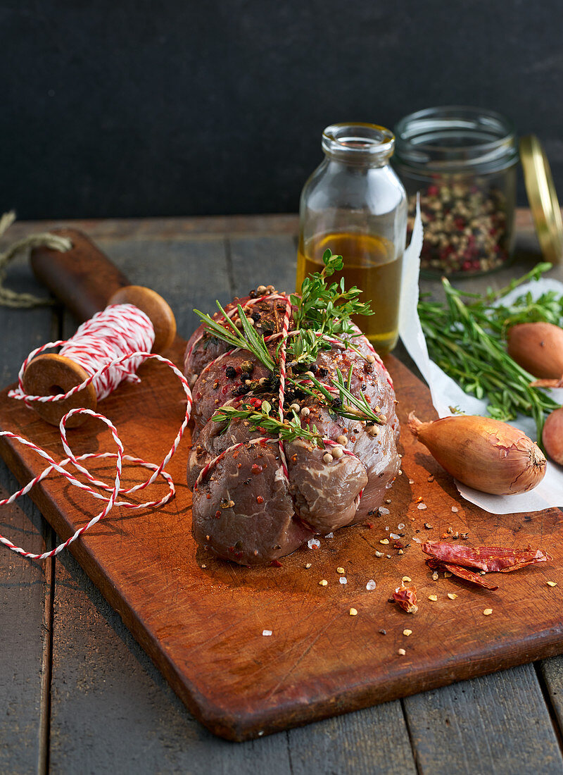 Raw, tied beef fillet prepared with herbs and various other ingredients