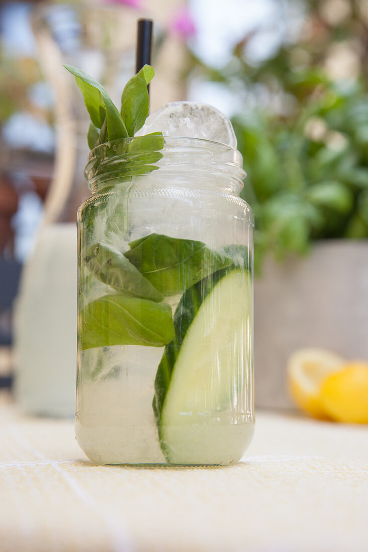 Lemonade with cucumber and basil outdoors