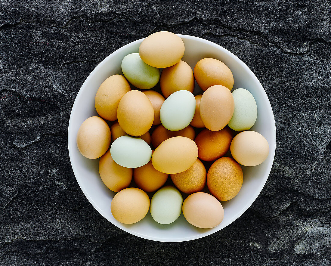 Various coloured eggs in a bowl