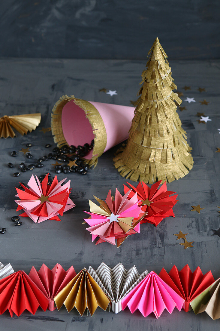 Christmas decorations hand-made from pink, red and gold paper