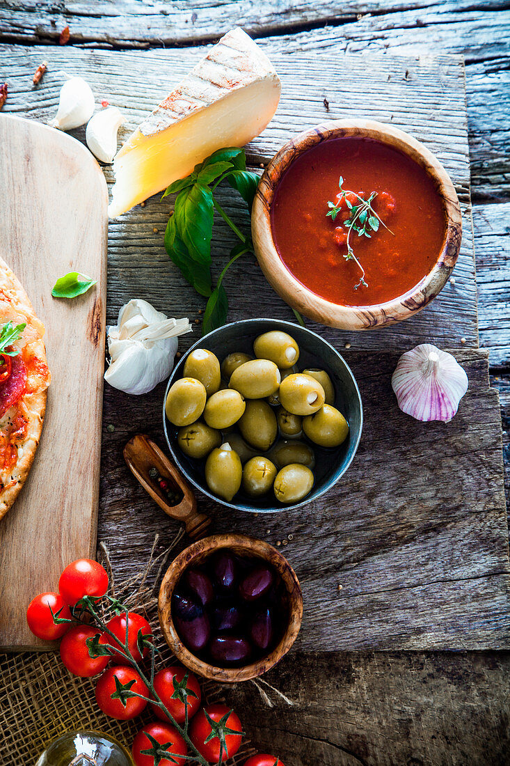 Fresh italian pizza ingredients on wood, cheese, salami and tomatoes