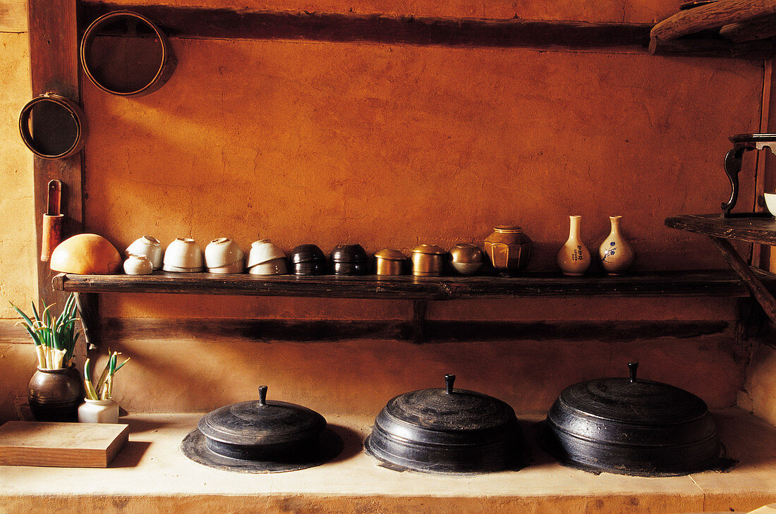 A traditional Korea kitchen with crockery and pots (Asia)