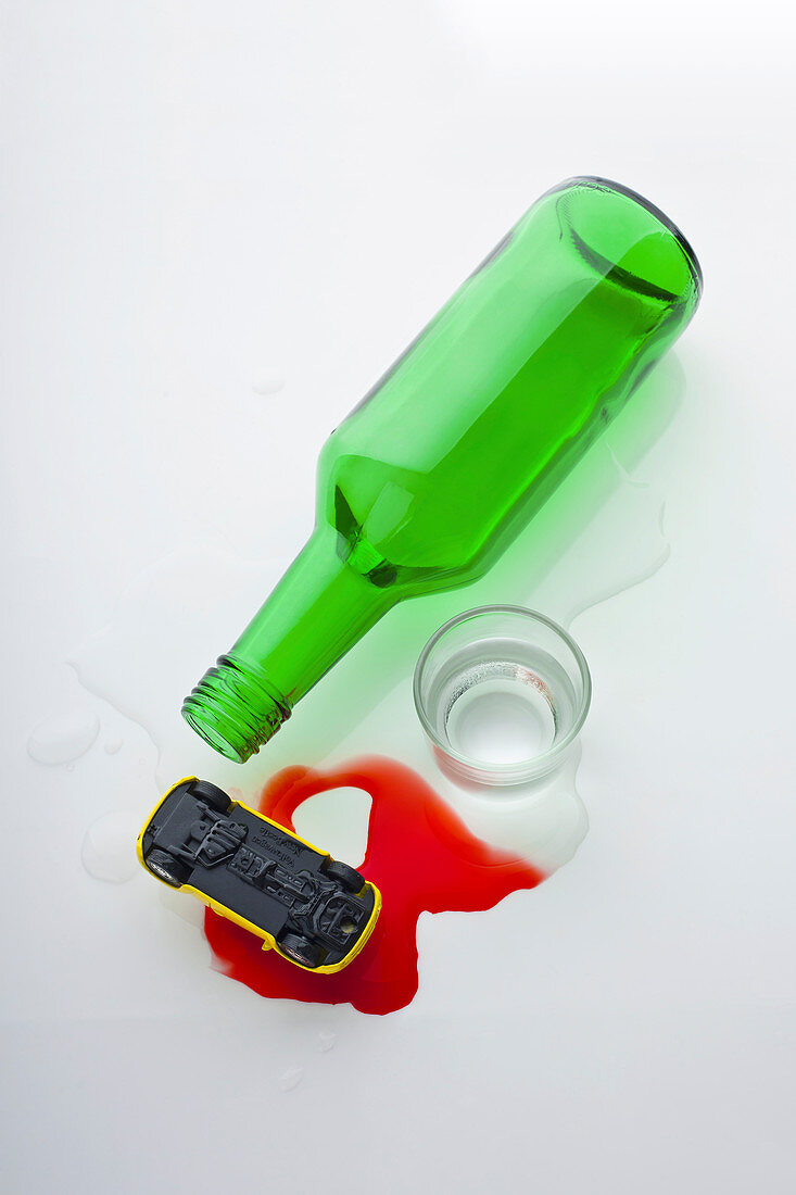 Drink driving warning: empty bottle, spilled soju, and a toy car