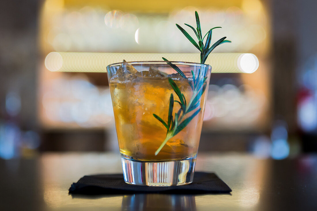A cocktail with rosemary