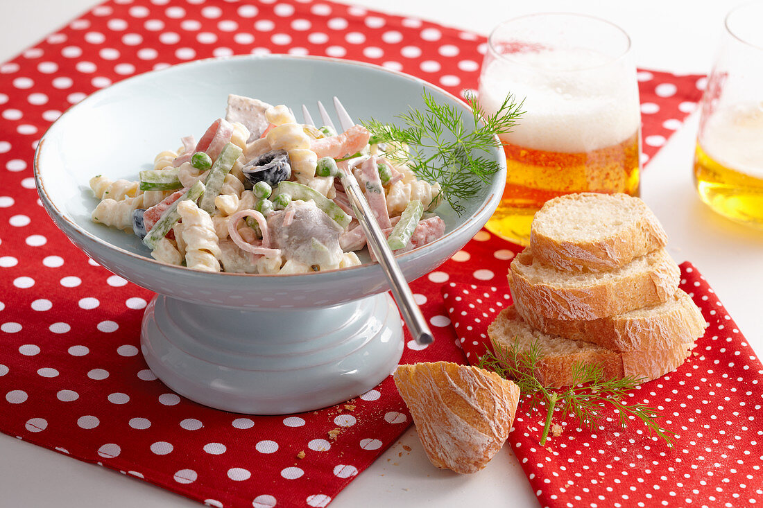 Spicy soused herring and pasta salad with slices of baguette