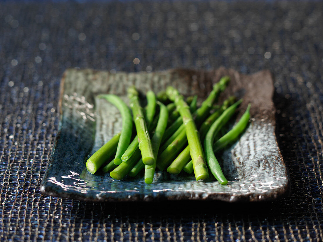 Green asparagus and green beans on a plate