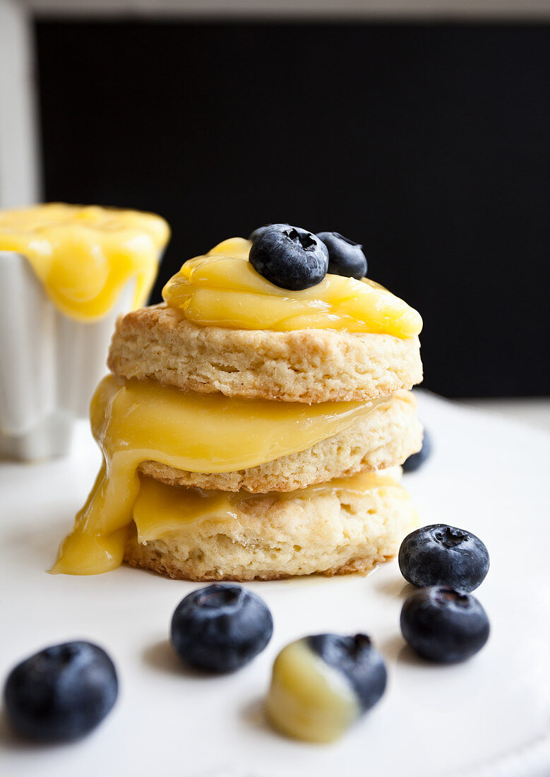 Three mini shortcakes stacked with lemon curd and blueberries