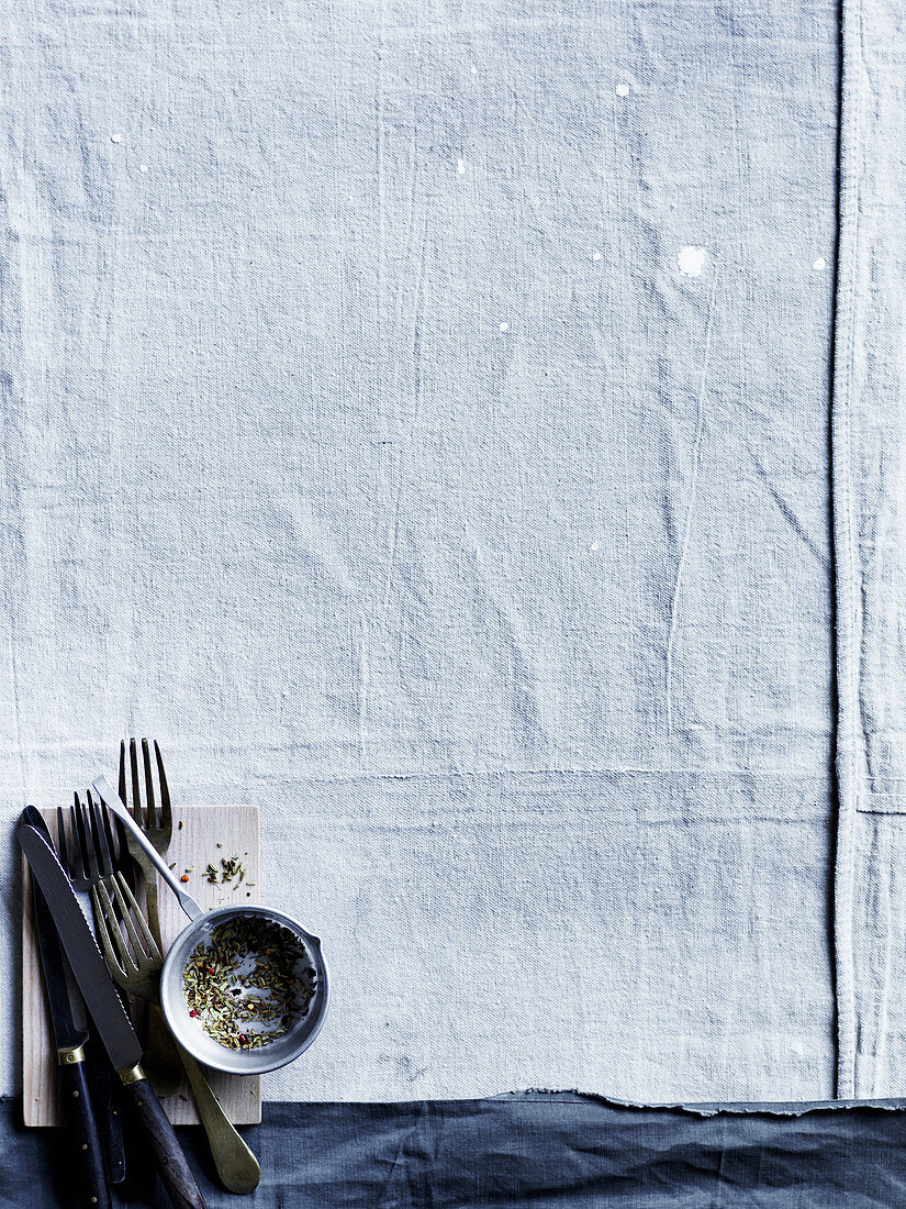 White tablecloth, cutlery and pepper
