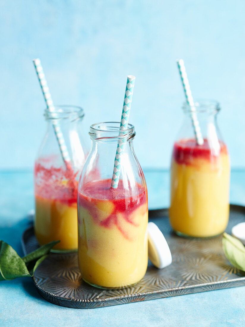 'Rising sun' orange smoothies with raspberries