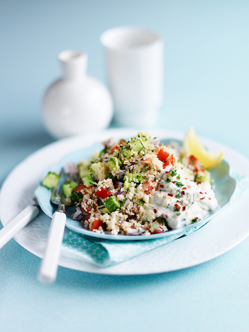 Couscous salad with lemon, cucumber, tomato, yogurt, onion and herbs