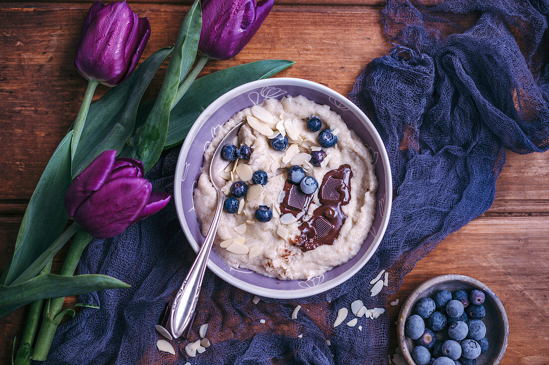 Semolina porridge topped with blueberries, chocolate and almonds