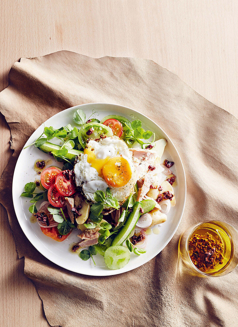 Salade nicoise with potatoes, heirloom tomatoes and a fried egg
