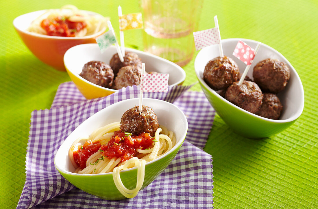 Small portions of spaghetti with tomato sauce and meatballs