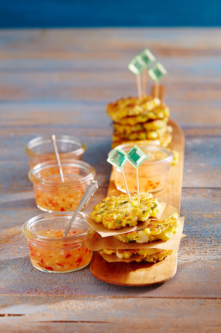 Mini prawn and sweetcorn fritters with chilli sauce in jars