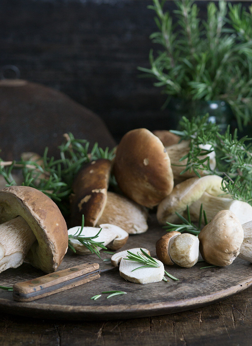 Fresh porcini mushrooms on a wooden plate
