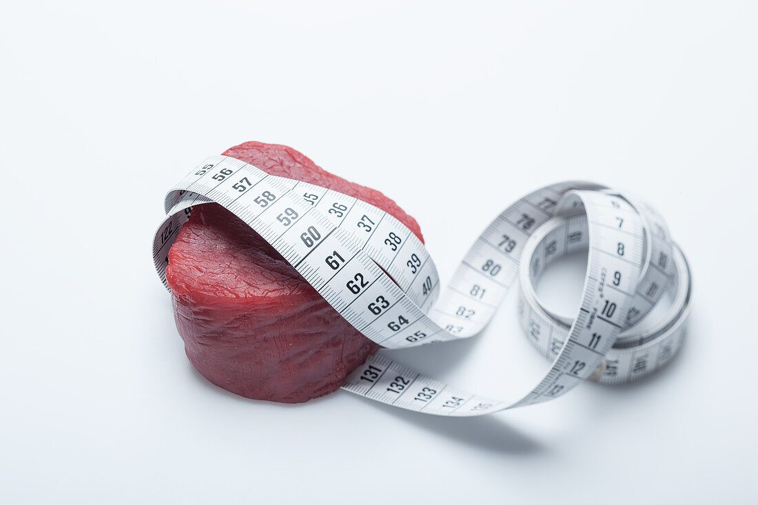 A raw fillet of beef with a tape measure