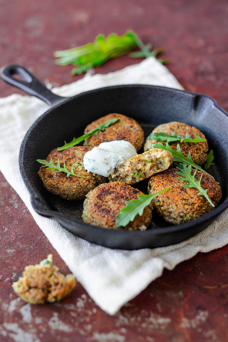 Quinoa croquettes with herb quark in a cast iron pan