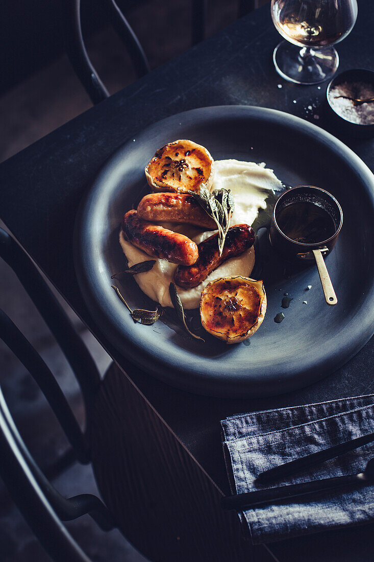 Bangers and Mash (sausages with mashed potatoes) with sherry glaze and roasted apples