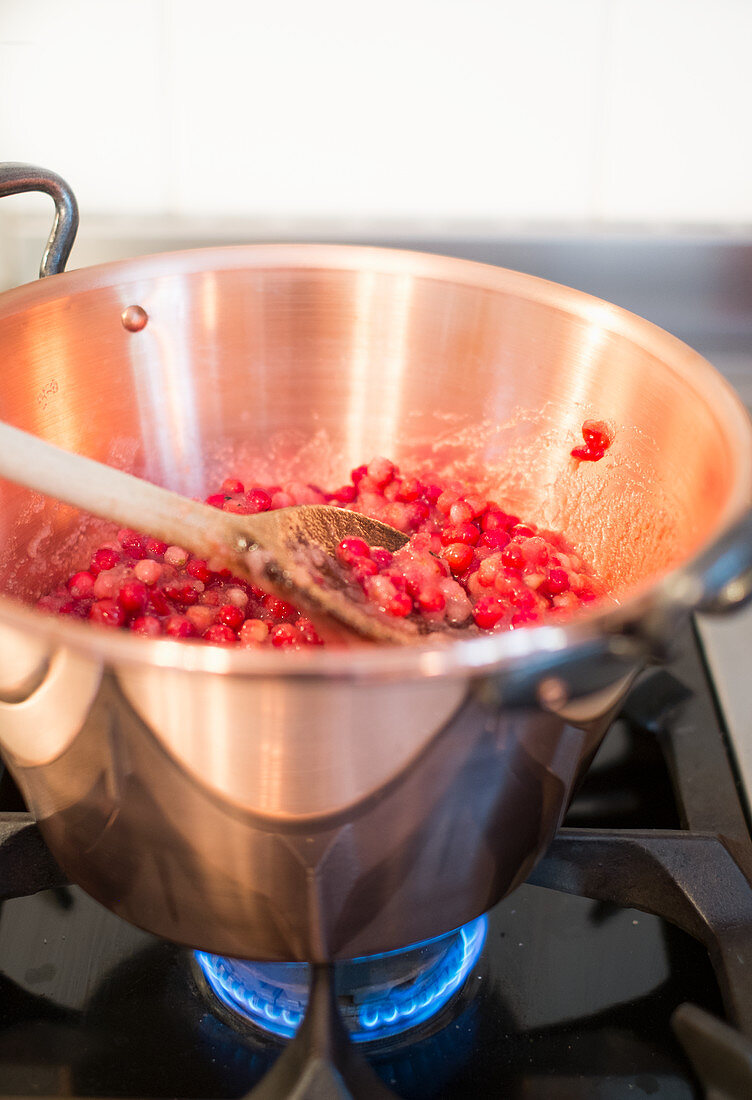Lingon berry jam being made, lingon berries being heated in a pot