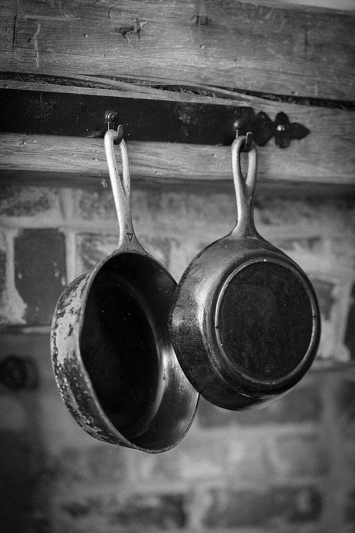Antique pans hanging on a wooden beam