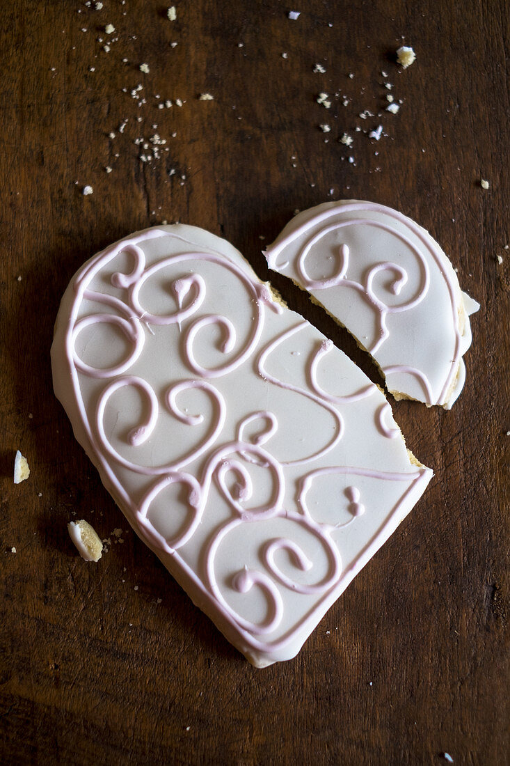 A broken, heart-shaped biscuit with icing