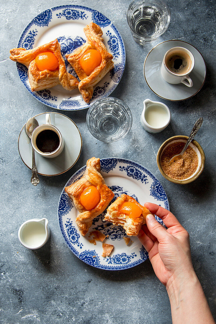 Young female holding a danish apricot pastry