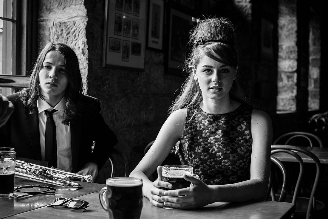 An elegantly dress couple in a restaurant (black-and-white shot)